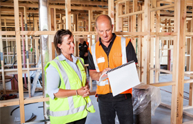 [Image] Construction workers onsite looking over plans. 