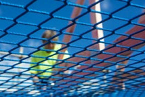 [image] Roof worker seen through underside of knotless square mesh safety net