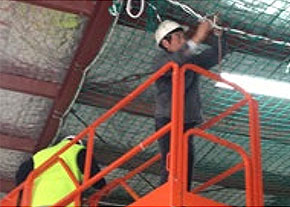 [image] View beneath a safety net containing debris