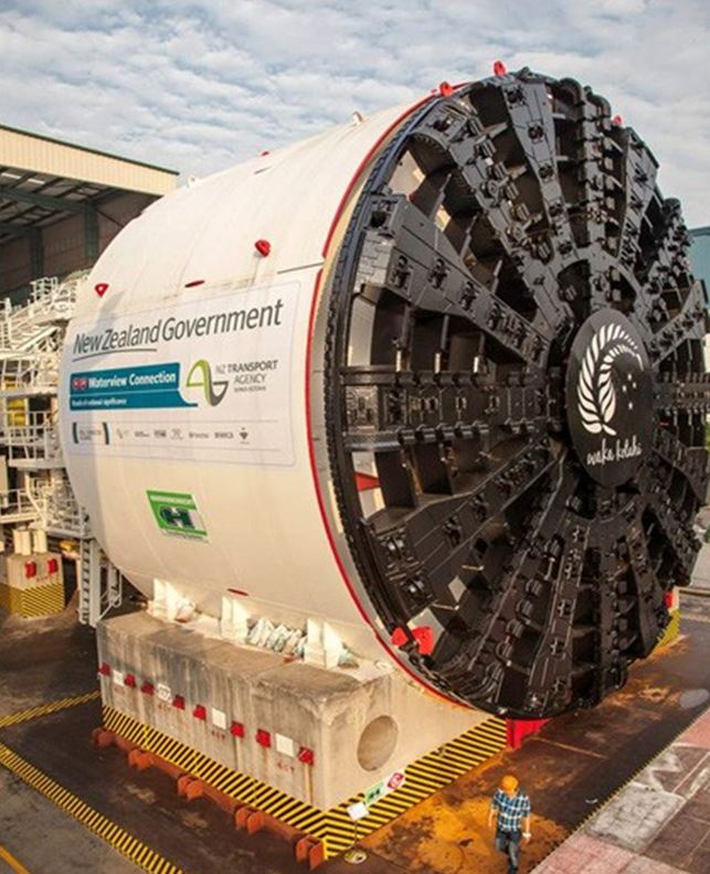 [image] tunnel boring machine with man walking past. 